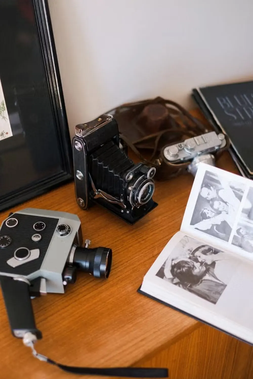 Vintage film cameras and lenses arranged on a desk